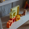 Colorful wooden blocks and toy train on a shelf