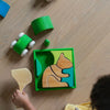 Child playing with wooden toys on a wooden floor