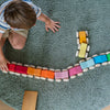 Child playing with a colorful toy on a green carpet