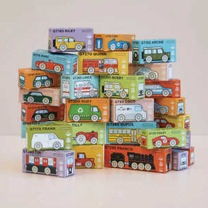 Stack of toy car boxes with various models on a light background