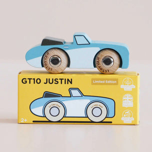 Toy car with wooden wheels on top of its packaging box, featuring the brand 'Lefroy Van'.