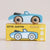 Toy car with wooden wheels on top of its packaging box, featuring the brand 'Lefroy Van'.