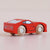 Red toy car with wooden wheels on a light pink background