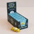 Le Toy Van toy car packaging with a yellow car in front on a beige background