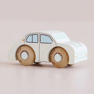 Toy car with wooden wheels on a beige background