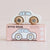 Toy car with wooden wheels on a pink box featuring 'GT110 RENE' branding.