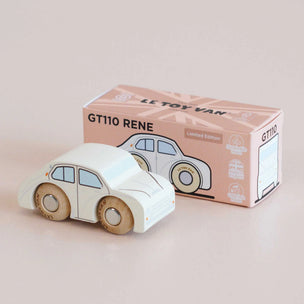 Wooden toy car with 'Le Toy Van' packaging on a beige background