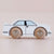 Toy car with wooden wheels on a beige background
