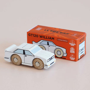 Wooden toy car model of a GT120 with its packaging on a beige background