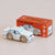 Wooden toy car model of a GT120 with its packaging on a beige background