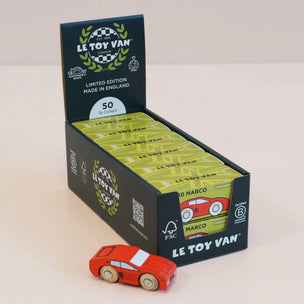 Display box of Le Toy Van toy cars with a red car in front on a light background