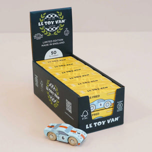 Le Toy Van toy cars in packaging with a single car in front on a beige background