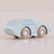 Light blue toy car with wooden wheels on a beige background
