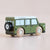 Toy vehicle with wooden wheels on a beige background