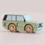 Wooden toy car with a light green body and brown wheels on a beige background