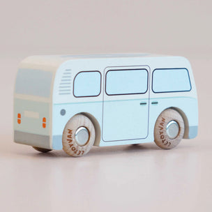 A wooden toy bus with a light blue and cream body, featuring printed wheels with the brand name 'LE TOY VAN'.