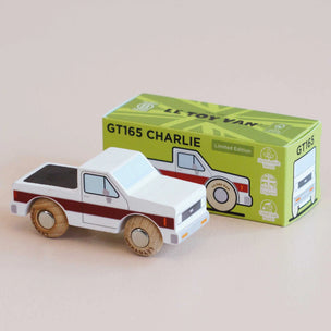 Wooden toy truck with a green box labeled 'Le Toy Van' on a beige background