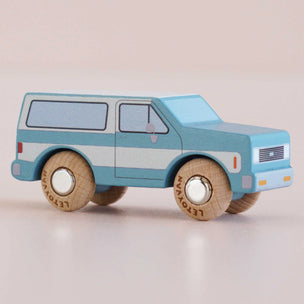 Toy truck with wooden wheels on a beige background