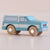 Toy truck with wooden wheels on a beige background