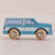 Toy van with wooden wheels on a light beige background