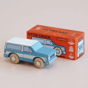 A wooden toy van with a light blue and white body and natural wood wheels, shown next to its orange retail box labeled 'GT170 CHUCK' and 'Limited Edition'.