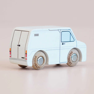 a deatailed white van with a veiw away from the van with a bage background 