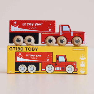 Red toy truck on top of its packaging box with 'Le Toy Van' branding.