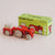 Wooden toy tractor with a green box labeled 'GT190 TILLY' on a beige background