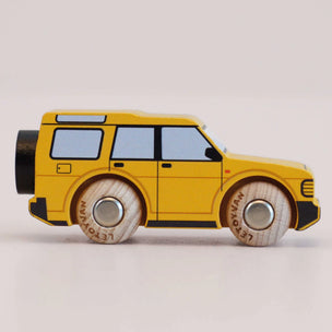 Yellow toy car with black accents on a light gray background
