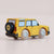 Yellow toy car with black and white wheels on a beige background
