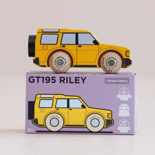 Yellow toy car on top of its packaging box with 'GT195 Riley' text on a light background