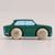Green toy car with wooden wheels on a light beige background