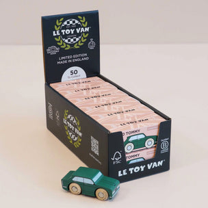 Display box of Le Toy Van toy cars with a green car in front on a light background