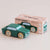 Green toy car with 'Le Toy Van' packaging on a beige background