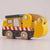 Wooden toy truck with a yellow body and gray roof on a light background