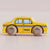 Toy taxi car with checkered pattern on wheels against a beige background