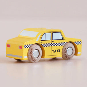 Toy taxi car with wooden wheels on a beige background