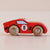Red wooden toy car with the number 8 on a beige background