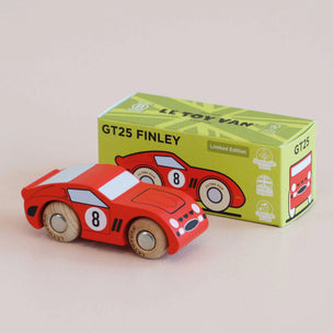 A red wooden toy race car with the number 8 on the side, shown in front of its green and yellow 'Le Toy Van GT25 Finley' packaging box on a light beige background.