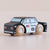 Wooden toy police car with American flag and 'POLICE' text on a beige background