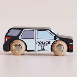 A wooden toy car designed as a police SUV with 'POLICE EMERGENCY' text and a star emblem on the side, featuring light wood wheels with 'LETOVAN' printed on them, set against a plain light beige background.