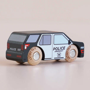 A wooden toy police car with a black and white painted body, realistic wood-grain wheels, and printed 'POLICE' and 'LET TOY VIAN' text, shown on a plain beige background.