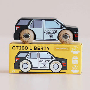 Wooden toy police car on top of its packaging box with 'GT260 Liberty' branding.
