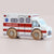 Wooden toy ambulance with red and white colors on a beige background
