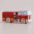 Red toy fire truck with wooden wheels on a beige background