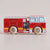 A wooden toy fire engine with a red body, white cab and windows, yellow stripes, and light wood wheels, shown on a plain light beige background.