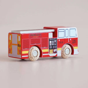 Wooden toy fire truck with red and white colors on a beige background