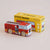 Red toy fire truck in front of its yellow packaging box labeled 'GT270 Quinn' on a beige background.