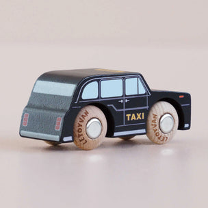 Toy taxi model on a plain background