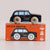 A black wooden toy taxi car with light wood wheels sits on top of its orange retail box. The box shows the text 'GT275 BERTIE' and 'Limited Edition' along with product feature icons.
